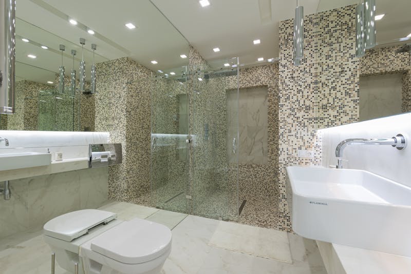 Glass shower and mosaic tile bathroom in Corona